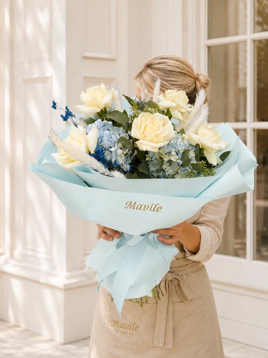 Coastal Grace Bouquet with ivory roses, blue hydrangea  and airy accents